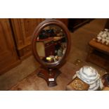 A hand made mahogany oval bathroom mirror