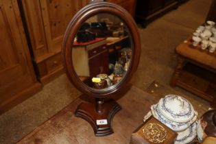 A hand made mahogany oval bathroom mirror