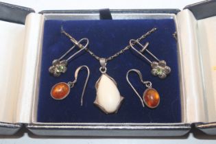 A silver pendant and two pairs of ear-rings