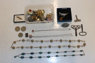A box containing costume jewellery, various coins