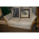 A light wood upholstered two seater settee and a m