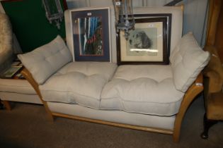 A light wood upholstered two seater settee and a m