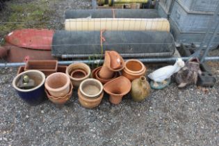 A quantity of various terracotta planters; glazed