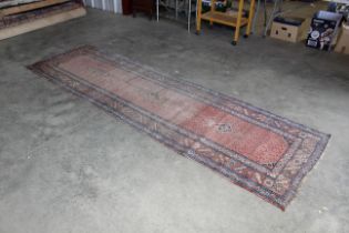 An approx. 10'8" x 3'2" patterned rug AF