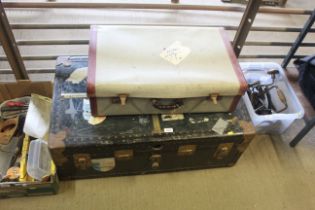 A metal bound travelling trunk and one suitcase
