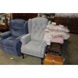 A button back upholstered wing armchair
