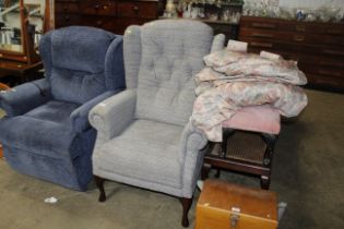 A button back upholstered wing armchair