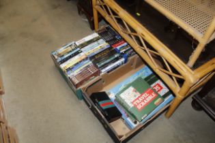 Two boxes containing various games, pens and DVDs