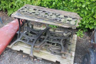 An ornate cast iron and wooden table and a quantit