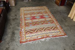 An approx. 7'7" x 4'8" patterned wool rug