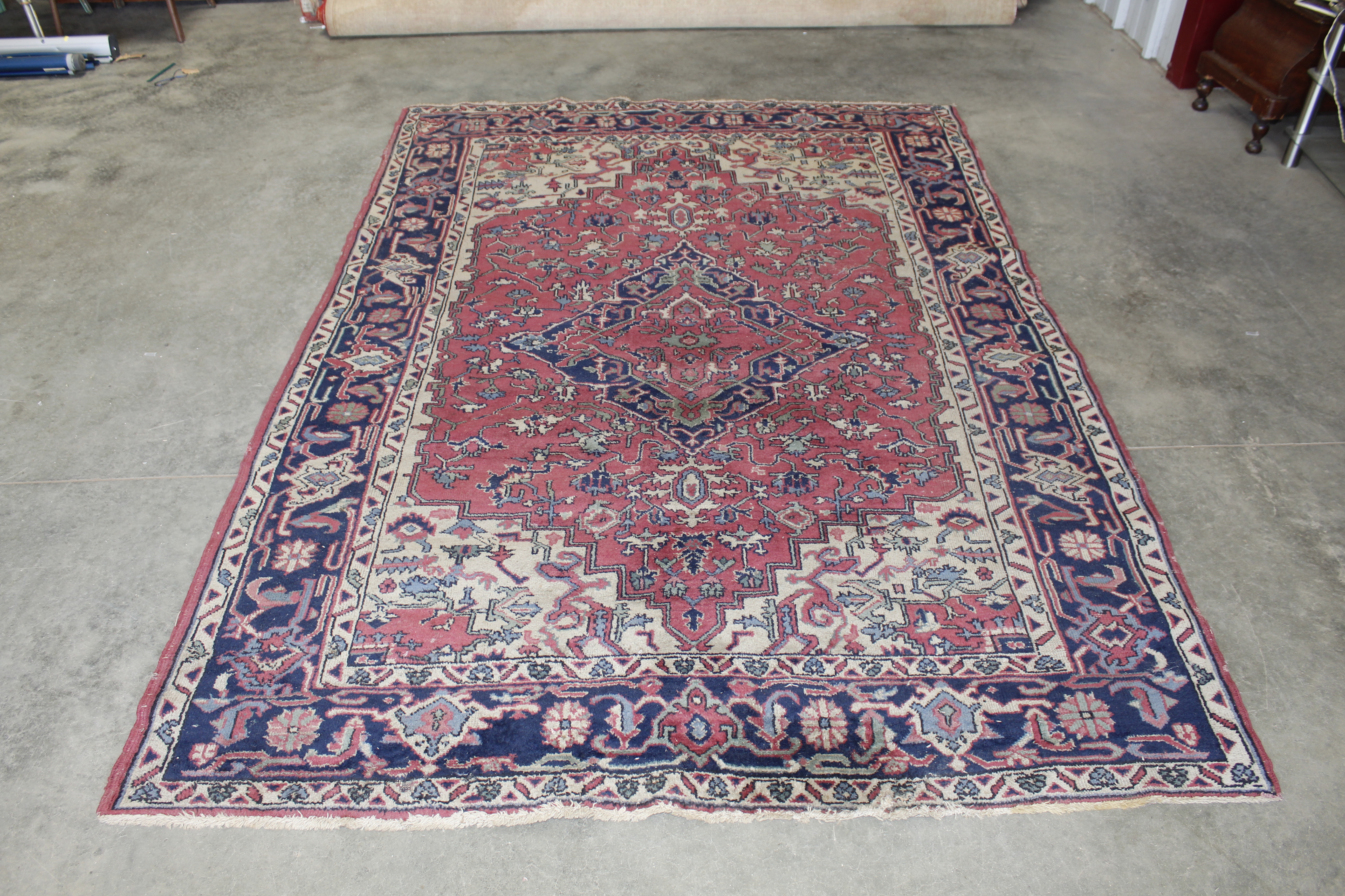 An approx. 9" x 6" blue and red patterned rug