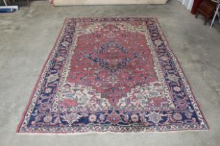 An approx. 9" x 6" blue and red patterned rug