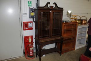 A late Victorian mahogany and glazed cabinet on st