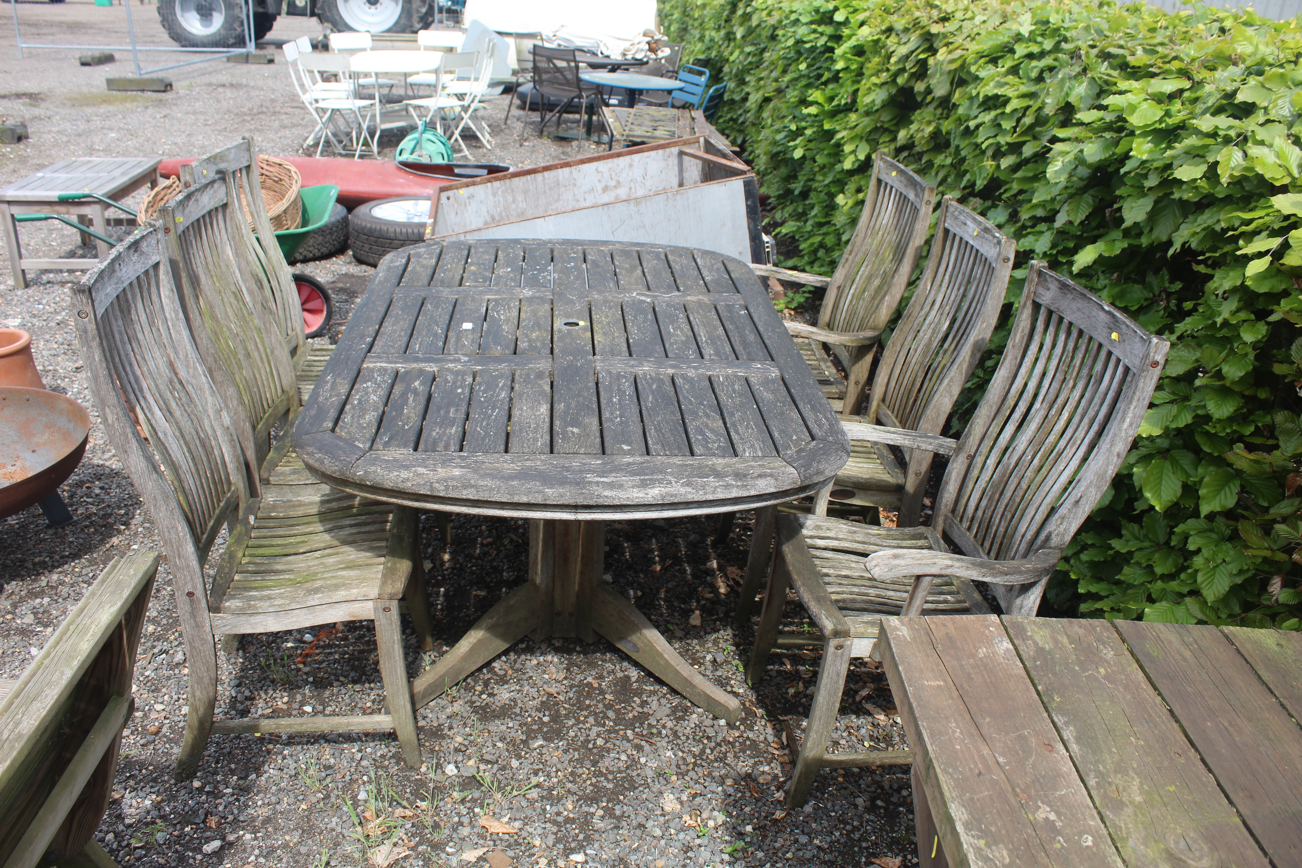 A hardwood garden table and set of six hardwood ga