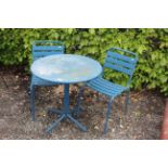 A small metal bistro set comprising circular table