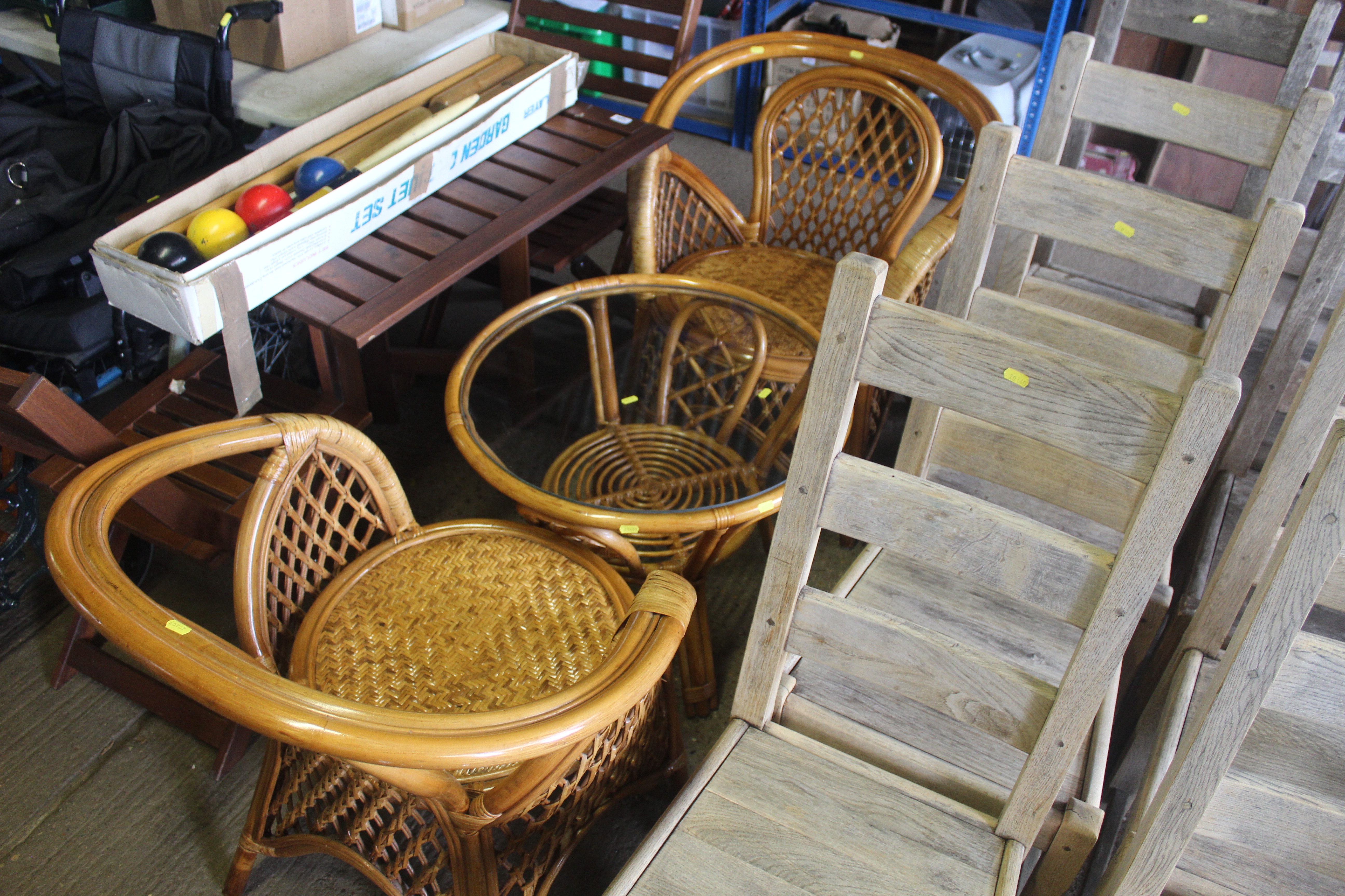 Two wicker armchairs and a circular wicker table w
