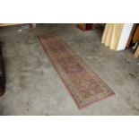 An approx. 9'8" x 2'3" patterned wool runner