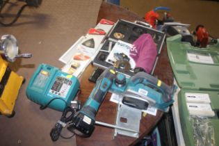 A Makita BKP180 cordless electric planer with manu