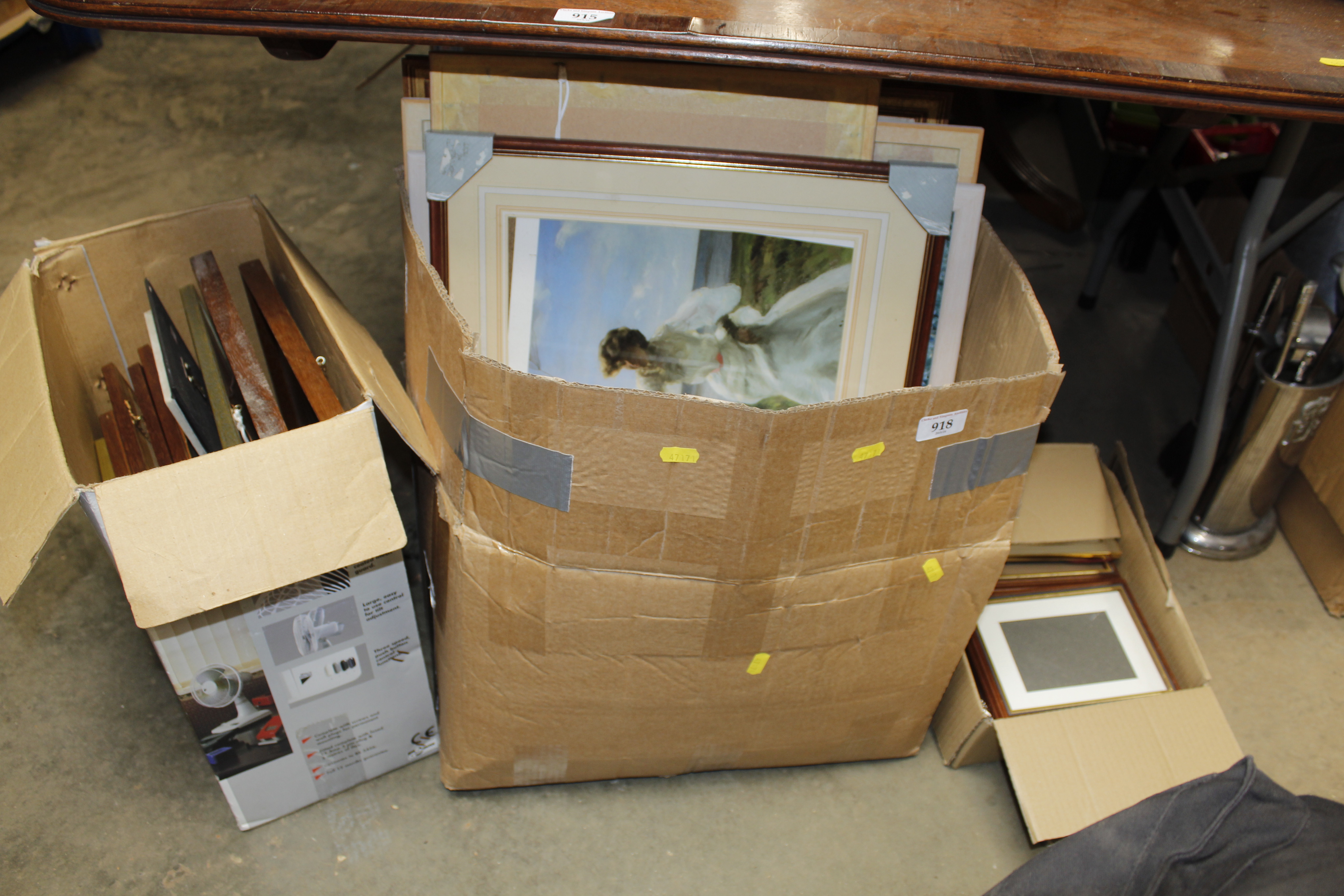 Three boxes containing various pictures and prints