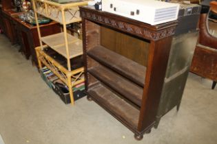 A mahogany open fronted bookcase with three adjust