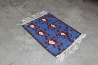 An approx. 5" x 3" Kilim rug