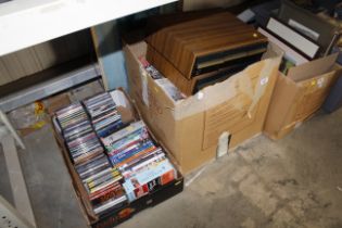 Two boxes containing DVDs, CDs, cassette tapes and