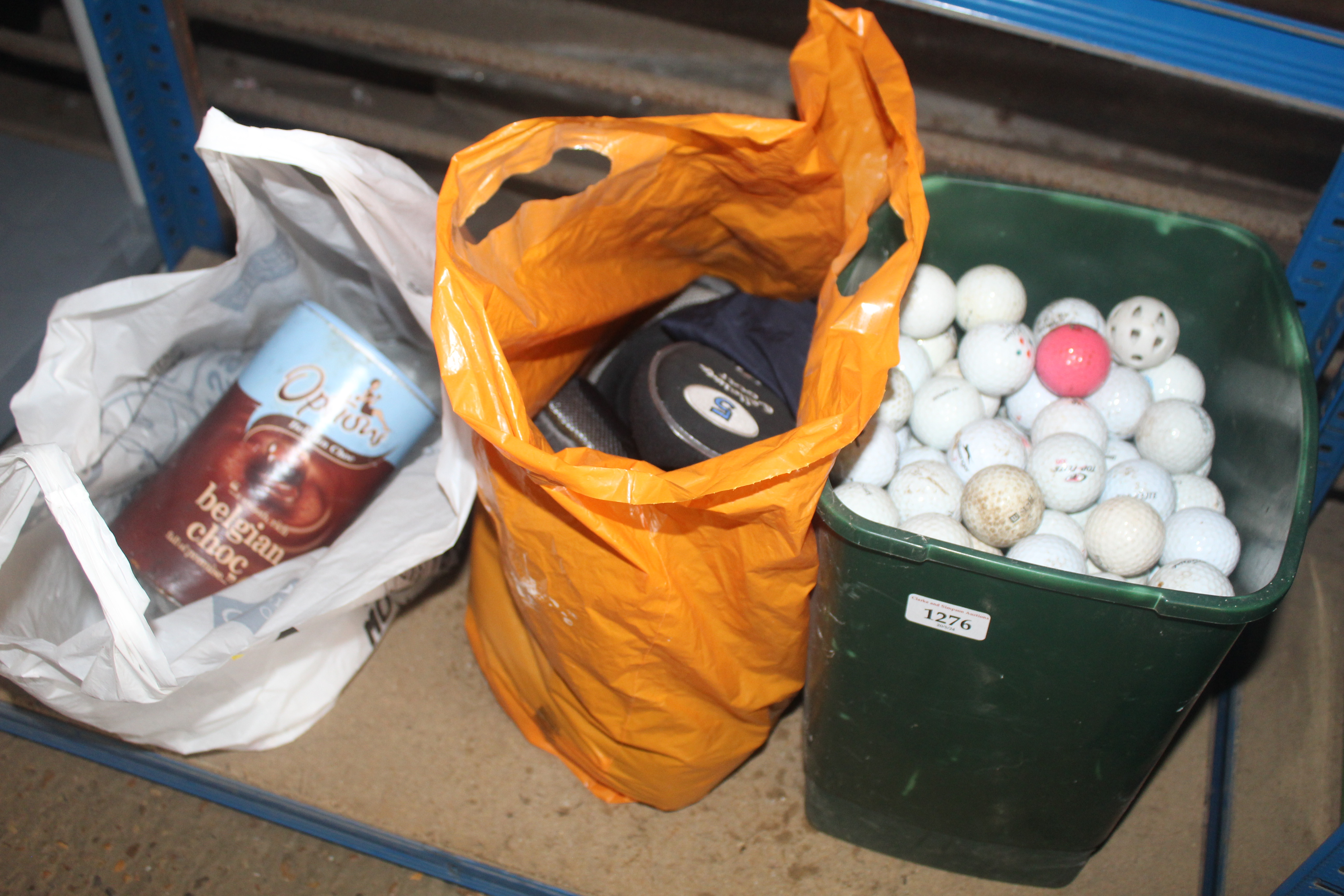 A tub containing a quantity of used golf balls, a