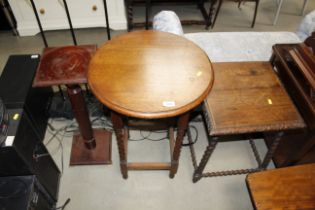 An oak side table raised on barley twist supports,