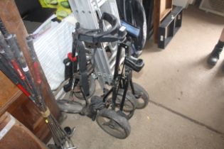 Two folding golf trolleys