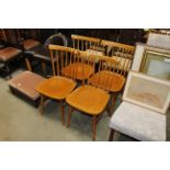 A set of four Ercol style stick back chairs