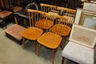 A set of four Ercol style stick back chairs