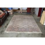 An approx. 9'1 x 6'4" pattern wool rug AF