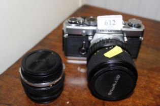 An Olympus OM-1 camera and two lenses