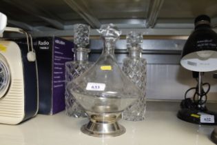 A pair of graduated cut glass decanters and a glas