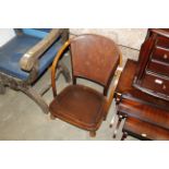 A wooden framed and leather back low chair