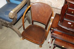 A wooden framed and leather back low chair