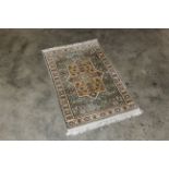 An approx. 3'7" x 2'2" eastern pattered rug