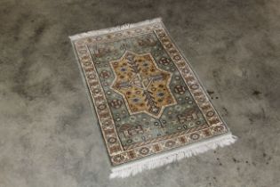 An approx. 3'7" x 2'2" eastern pattered rug