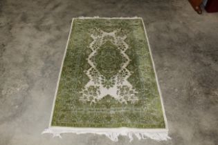 An approx. 5'7 x 3" green patterned rug