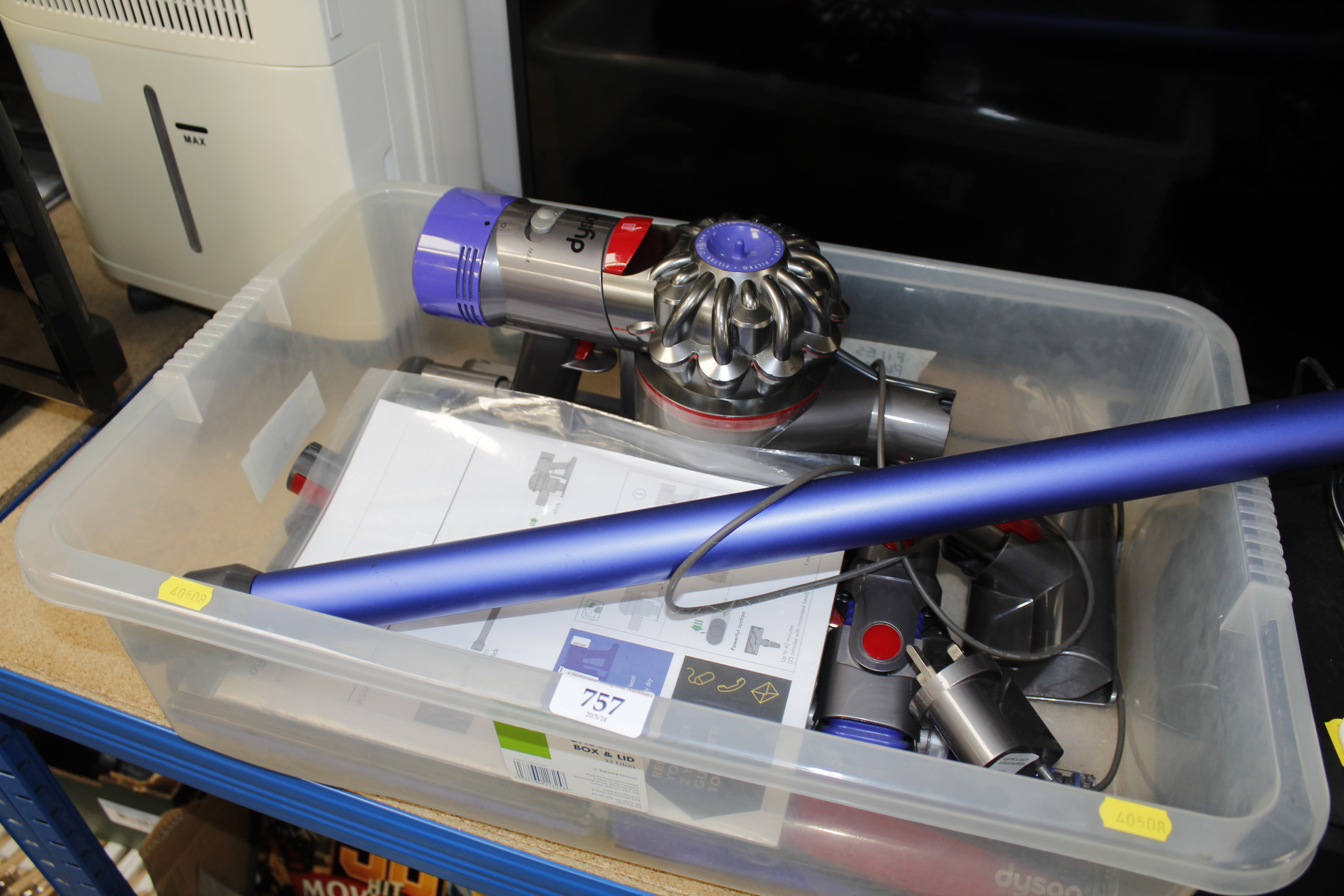 A Dyson V8 vacuum cleaner with various accessories