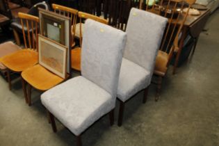 A pair of modern upholstered dining chairs