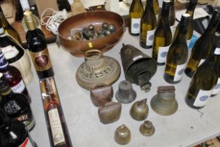 A collection of various brass bells, a powder meas