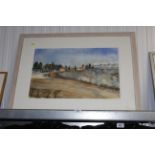 A framed watercolour study of a continental landsc