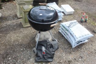 A Weber charcoal BBQ, various BBQ implements and a