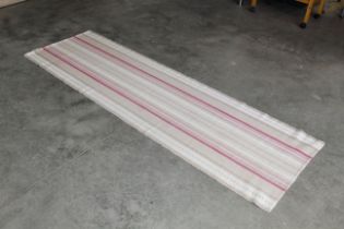An approx. 7'10 x 2'5 modern patterned rug