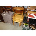 A nest of three beech occasional tables and a teak