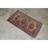 An approx. 3'8" x 1'10" patterned rug AF