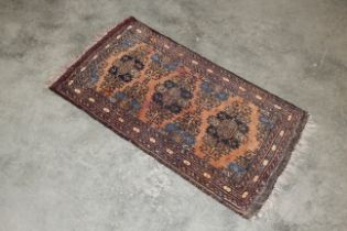 An approx. 3'8" x 1'10" patterned rug AF
