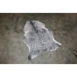 An approx. 4" x 2'8" sheepskin rug