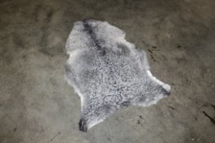 An approx. 4" x 2'8" sheepskin rug